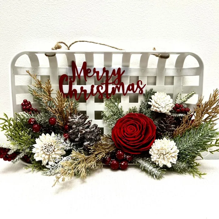 Merry Christmas floral arrangement with roses and pine cones