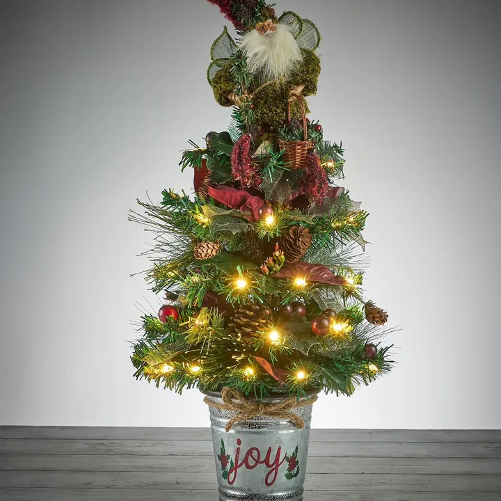 Small decorated Christmas tree in a Joy tin