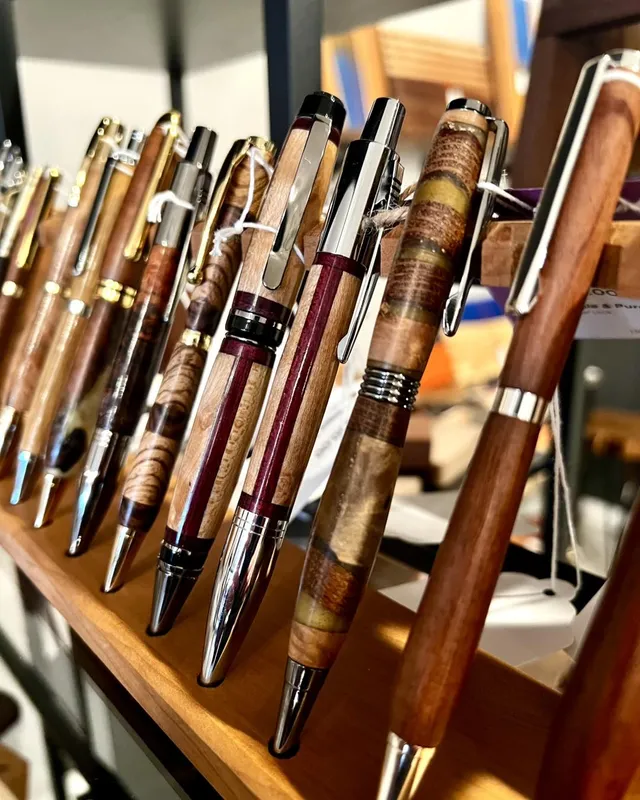 A row of handmade turned wooden pens